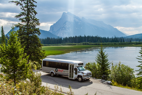 24 Passenger Bus in front of Vermilion Lakes in Banff